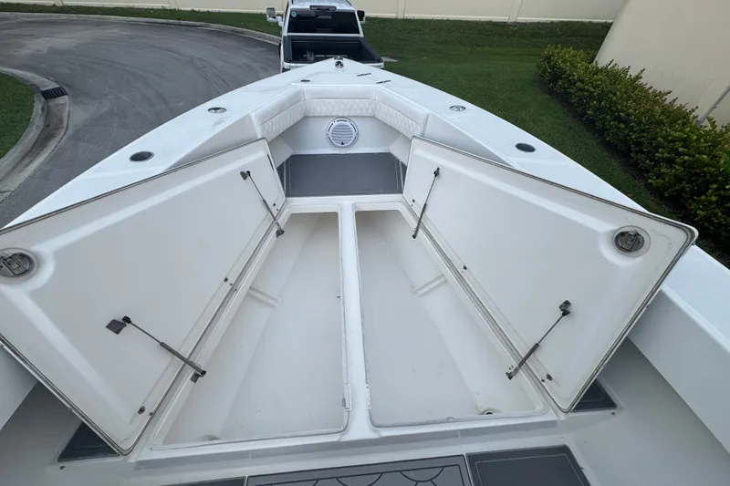 Slide: The Image of 1997 Venture 34 Center Console boat with open storage compartments on deck. - 16