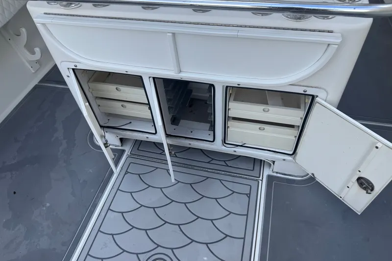 Slide: The Image of Open storage compartments on a 1997 Venture 34 Center Console boat deck. - 32