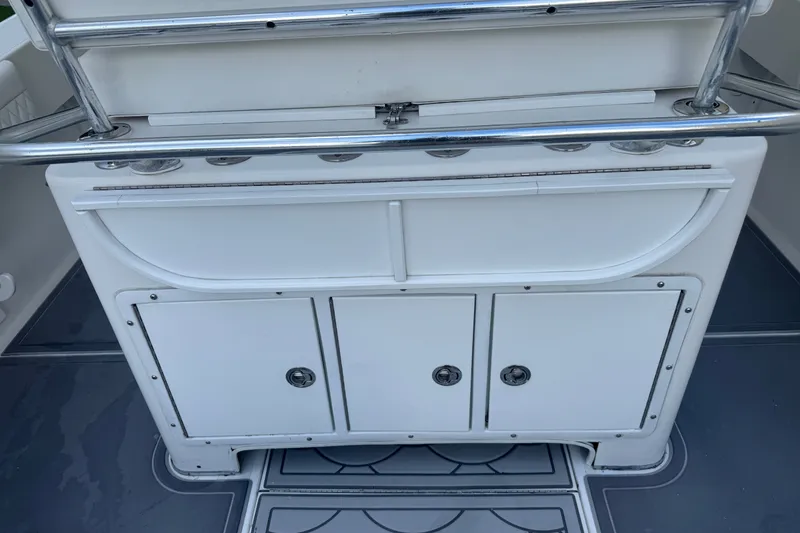 Slide: The Image of 1997 Venture 34 Center Console boat interior with storage compartments and stainless steel railing. - 31