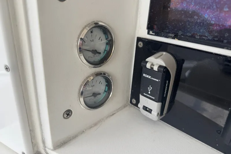 Slide: The Image of Fuel gauges and USB charger on 1997 Venture 34 Center Console boat dashboard. - 25