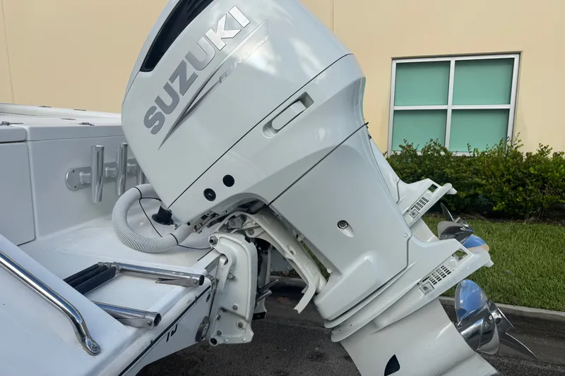 Slide: The Image of Outboard motor on a 1997 Venture 34 Center Console boat, featuring Suzuki branding. - 13