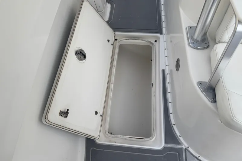 Slide: The Image of Open storage compartment on a 1997 Venture 34 Center Console boat deck. - 27
