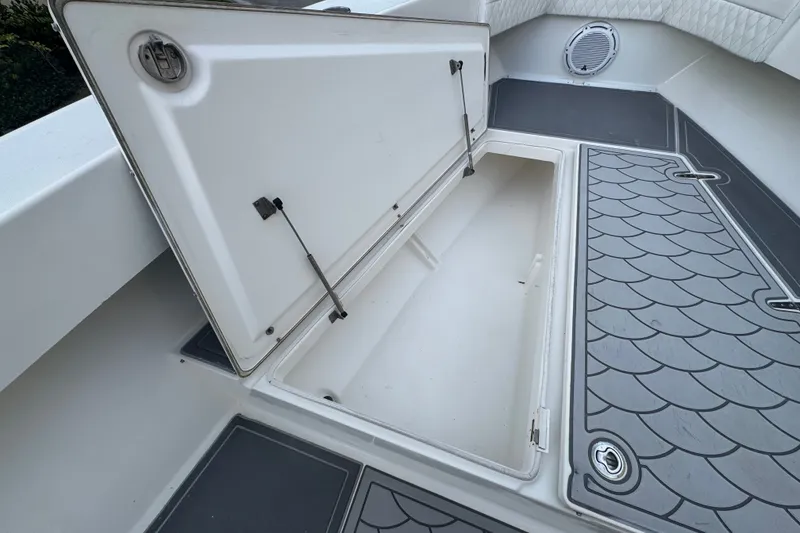 Slide: The Image of Open storage compartment on 1997 Venture 34 Center Console boat with textured flooring. - 18