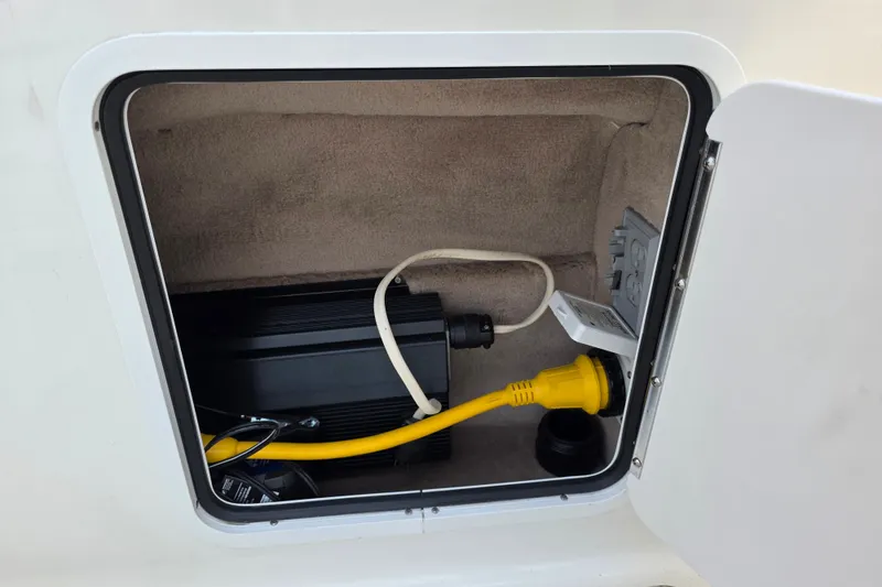 Slide: The Image of Electrical compartment of 1997 Sea Ray 250 Sundancer with cables and outlets. - 11