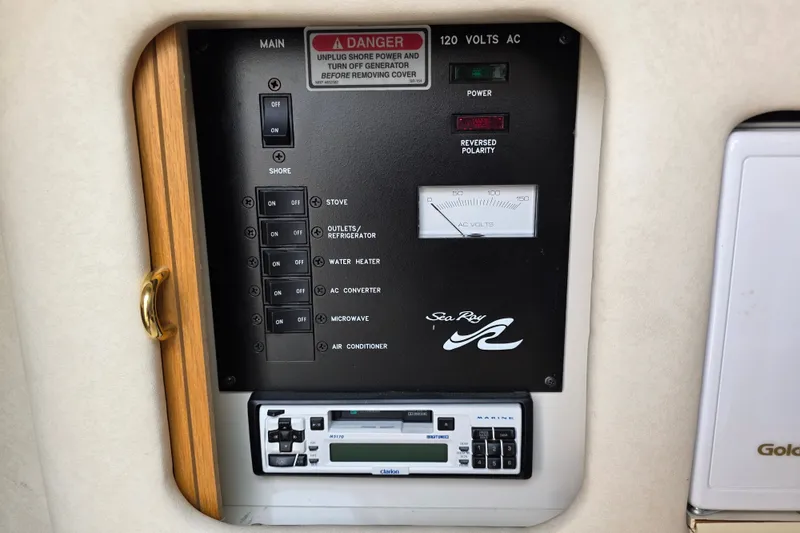 Slide: The Image of Control panel of a 1997 Sea Ray 250 Sundancer boat, featuring power switches and voltage meter. - 23