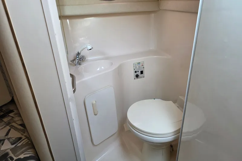 Slide: The Image of 1997 Sea Ray 250 Sundancer boat bathroom with sink and toilet. - 15