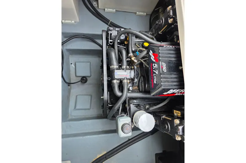 Slide: The Image of Engine compartment of a 1997 Sea Ray 250 Sundancer with a 5.7L MerCruiser engine. - 24