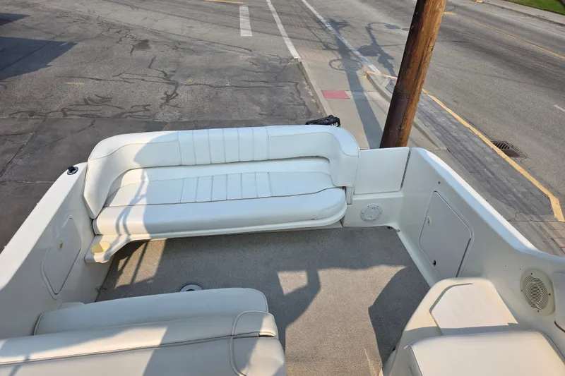 Slide: The Image of 1997 Sea Ray 250 Sundancer boat interior with white seating and carpeted floor. - 5