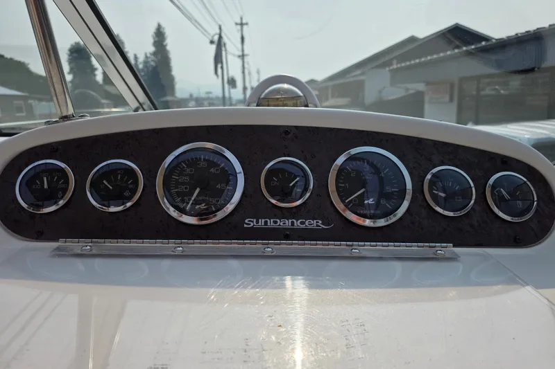 Slide: The Image of Dashboard of a 1997 Sea Ray 250 Sundancer boat with gauges and controls. - 9
