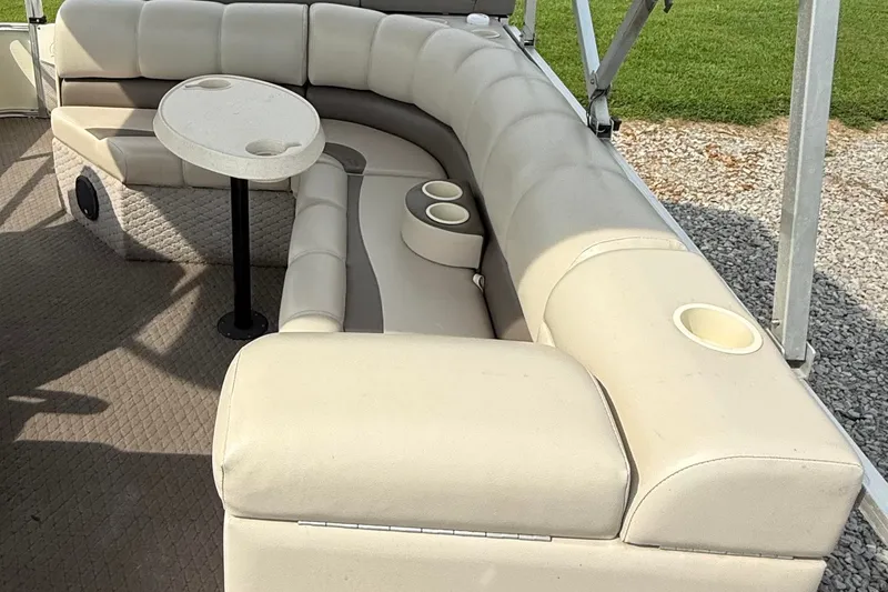 Slide: The Image of Luxurious seating area on a 2005 Avalon Paradise Elite 2425 pontoon boat with cup holders and table. - 8