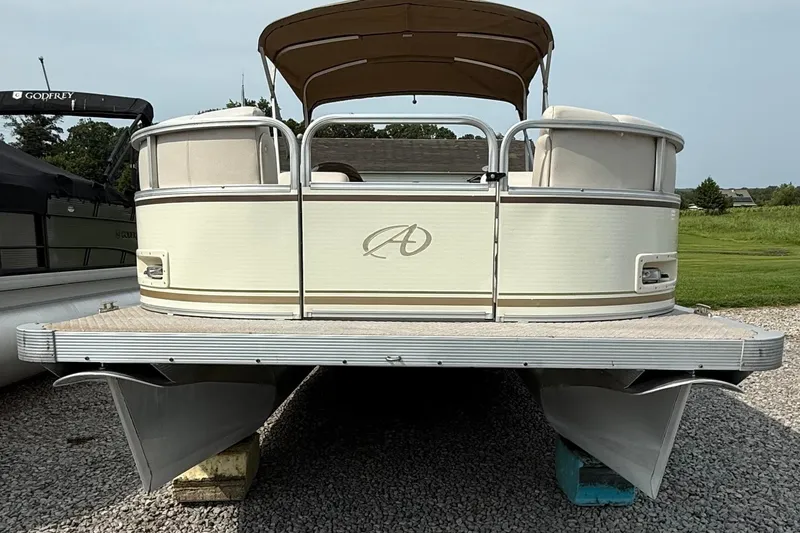 Slide: The Image of 2005 Avalon Paradise Elite 2425 pontoon boat on gravel, front view. - 4