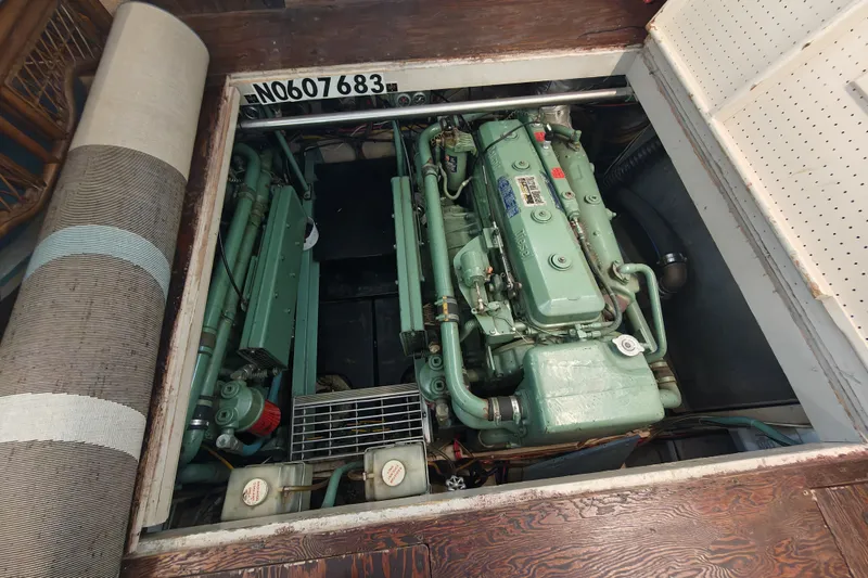 Slide: The Image of A view of the engine room of a 1979 Viking 42 boat with two large green engines. - 23
