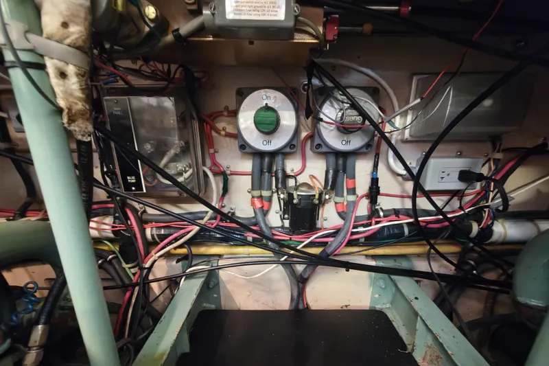 Slide: The Image of Electrical panel with wires and switches in a boat's engine compartment. - 25
