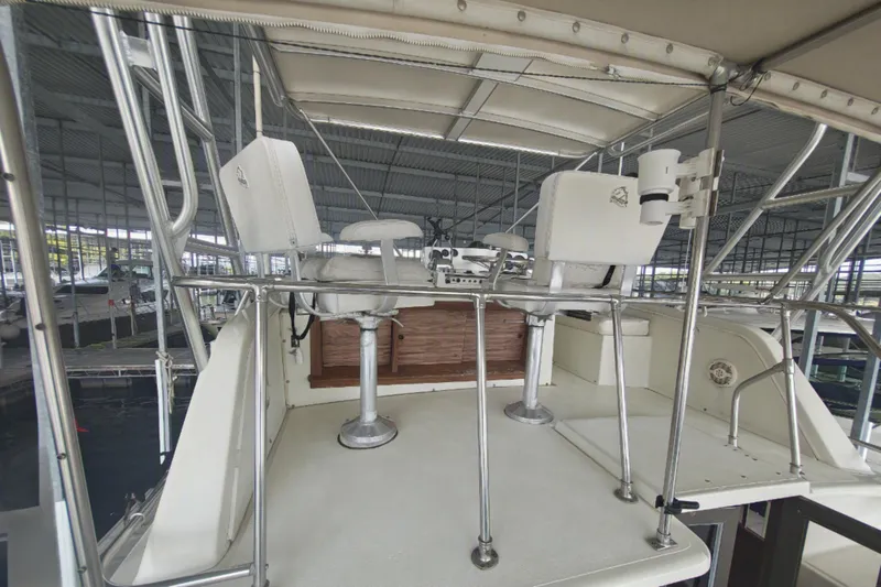Slide: The Image of The image shows the helm of a 1979 Viking 42 with two white captain's chairs. - 9