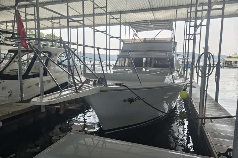 The Image of A 1979 Viking 42 boat docked under a covered marina. - 0