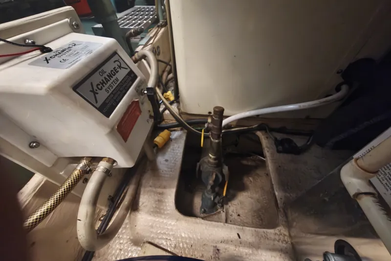 Slide: The Image of An engine room with an oil change system and various hoses and cables. - 28