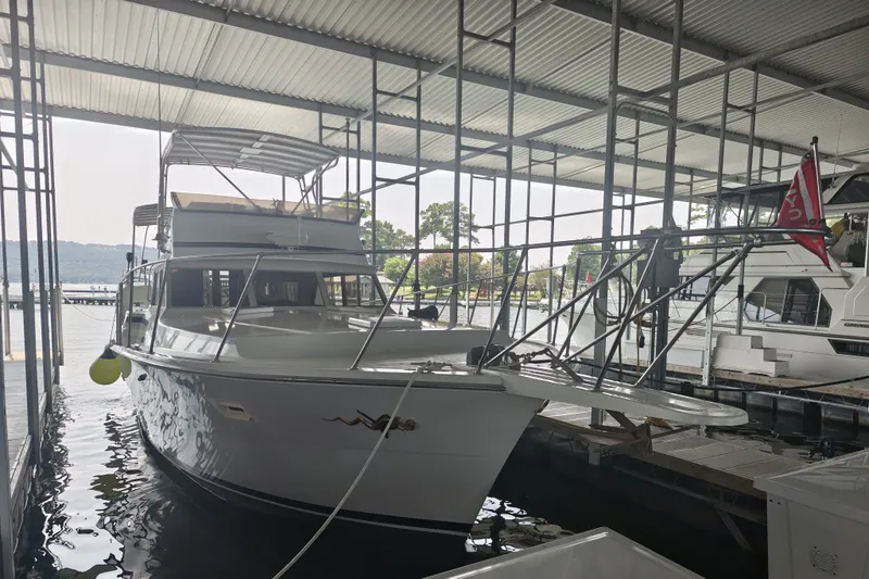 Slide: The Image of A 1979 Viking 42 boat is docked under a covered marina. - 2