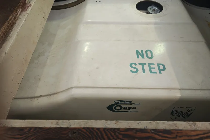 Slide: The Image of A part of a boat engine with "NO STEP" and an Onan logo visible. - 31