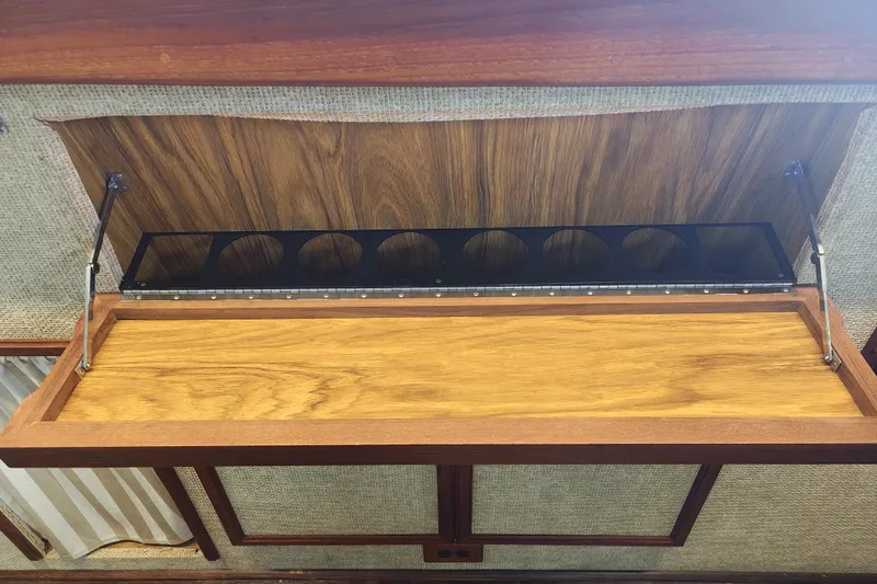Slide: The Image of A wooden shelf with glass holders inside a boat. - 15