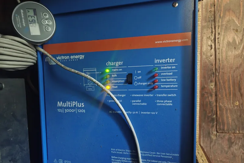 Slide: The Image of A Victron Energy MultiPlus charger and inverter with various indicators and a digital display. - 17