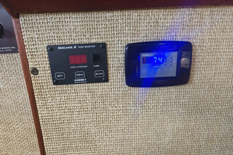 Slide: The Image of Two electronic displays are embedded in a wall, one showing the tank level. - 14