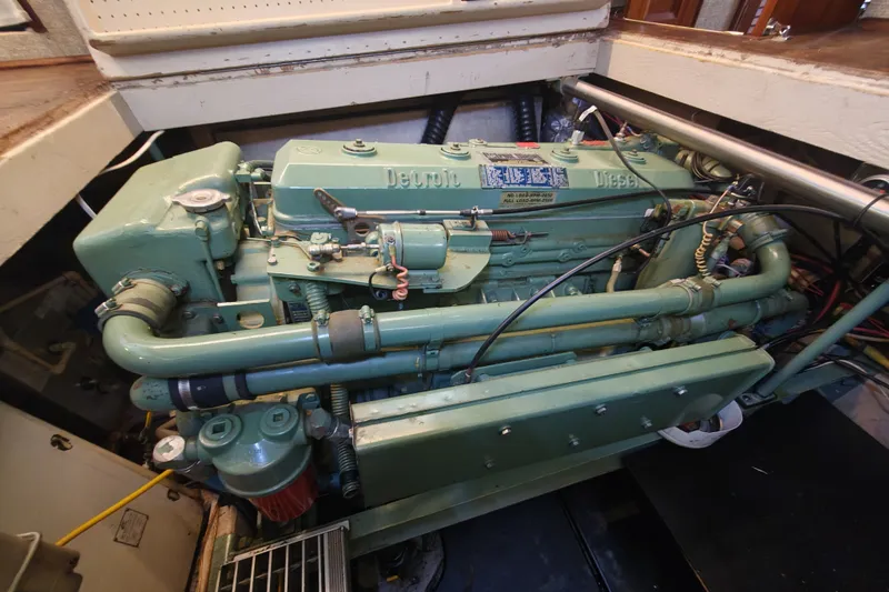 Slide: The Image of A green engine in a boat's engine room, surrounded by pipes and cables. - 22