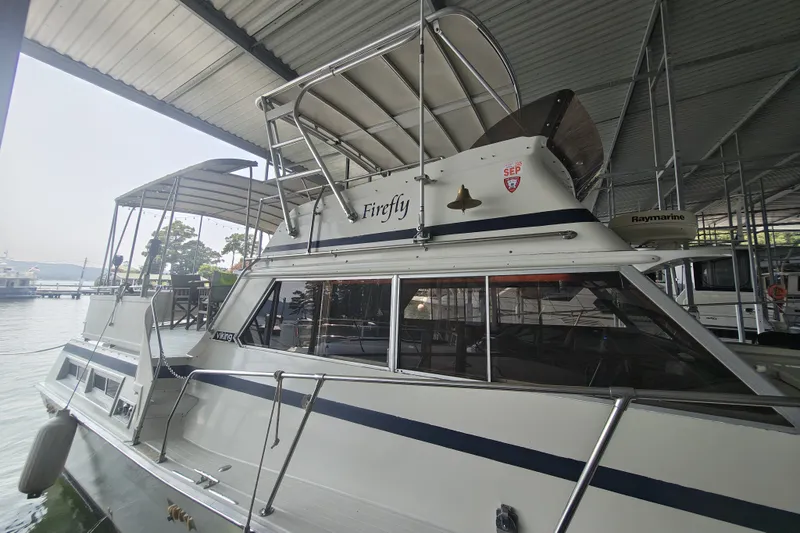 Slide: The Image of A 1979 Viking 42 boat docked in a covered marina. It features an elevated helm. - 5