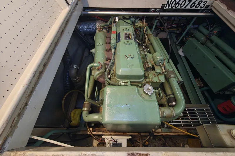 Slide: The Image of An engine compartment with a green engine inside a boat. - 21