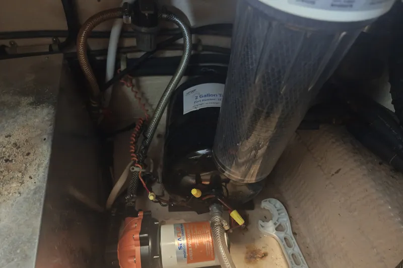 Slide: The Image of An engine compartment with hoses and a filter in a boat. - 29