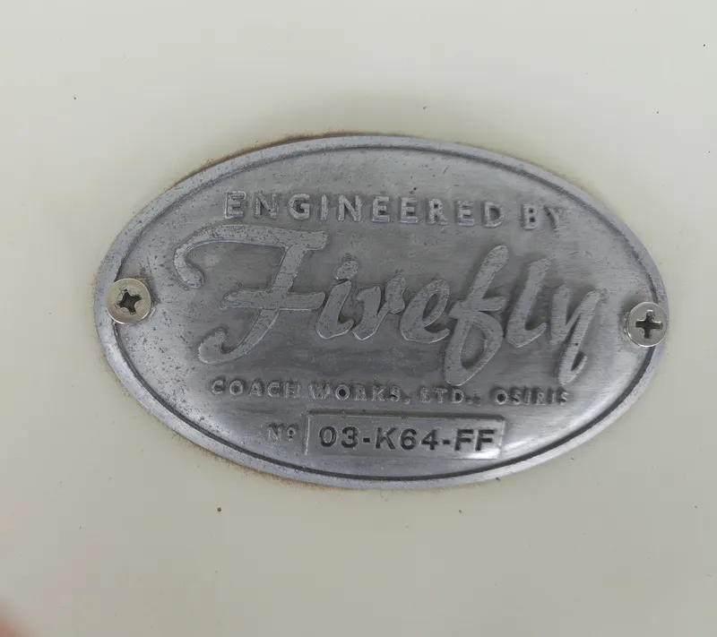 Slide: The Image of Metal plaque reading "Engineered by Firefly" with serial number on a light background. - 11