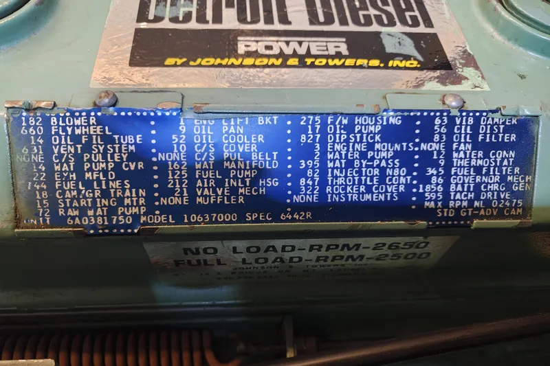 Slide: The Image of An engine with a detailed maintenance and specifications plaque. - 24