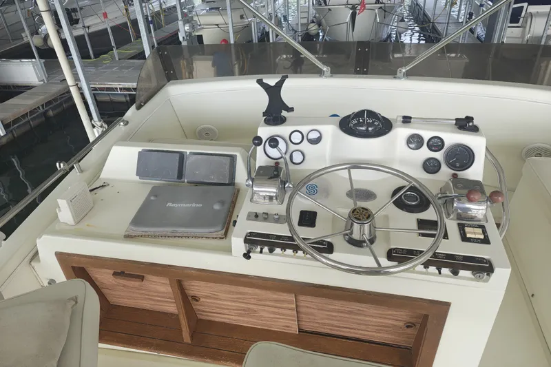 Slide: The Image of The image shows the helm of a 1979 Viking 42 with various instruments and wooden cabinets. - 10