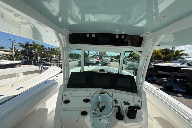 Slide: The Image of 2019 HCB 42 Siesta boat cockpit with modern navigation equipment and sleek design. - 18