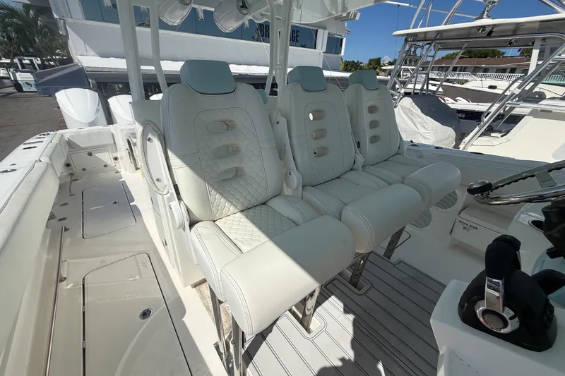 Slide: The Image of Luxurious seating on a 2019 HCB 42 Siesta boat, featuring white leather upholstery. - 23