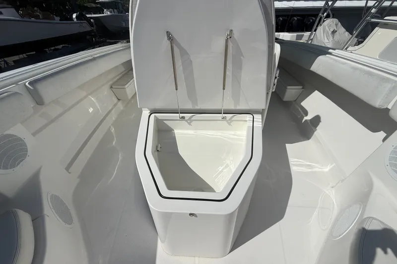 Slide: The Image of 2019 HCB 42 Siesta boat with open storage compartment, showcasing sleek white interior design. - 31