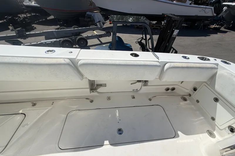 Slide: The Image of 2019 HCB 42 Siesta boat interior with white seating and storage compartments. - 14