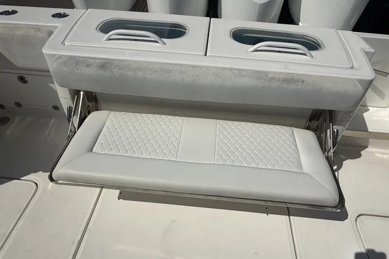 Slide: The Image of 2019 HCB 42 Siesta boat with foldable white cushioned seat and storage compartments. - 3