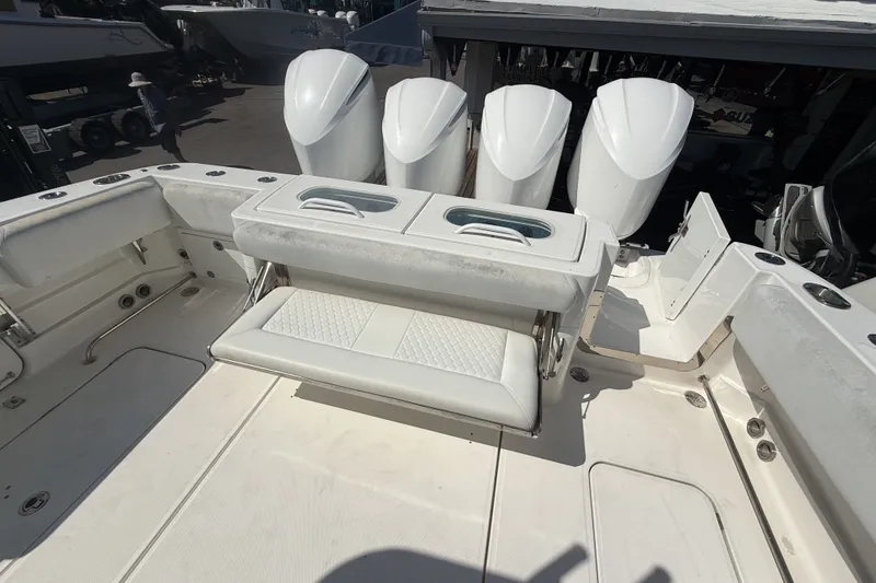Slide: The Image of 2019 HCB 42 Siesta boat deck with seating and four powerful outboard engines. - 13