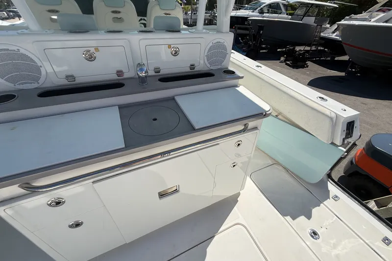 Slide: The Image of 2019 HCB 42 Siesta boat interior with storage compartments and seating area. - 7