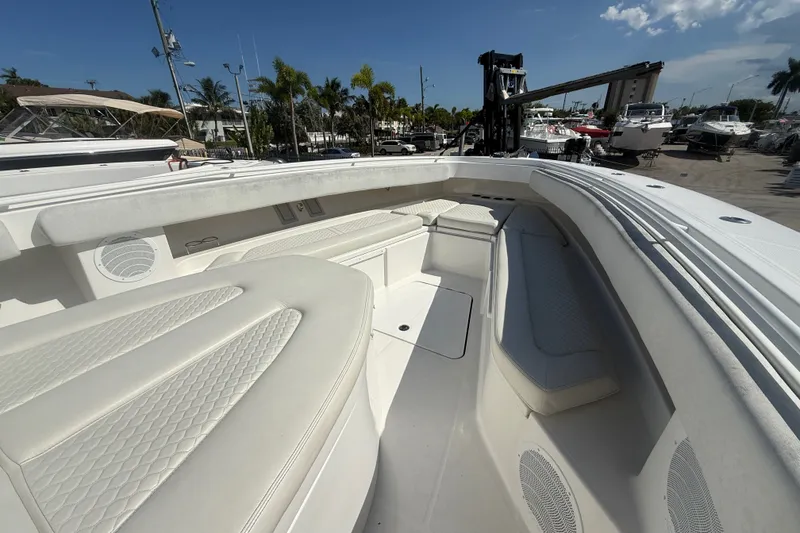 Slide: The Image of 2019 HCB 42 Siesta boat interior with white seating and spacious deck. - 26