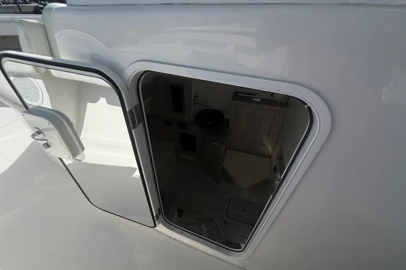Slide: The Image of 2019 HCB 42 Siesta boat cabin interior with open door, showcasing compact design. - 34