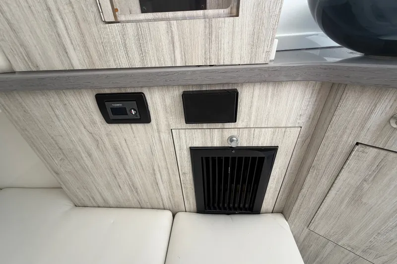 Slide: The Image of Interior of 2019 HCB 42 Siesta boat with modern wood paneling and control panel. - 38