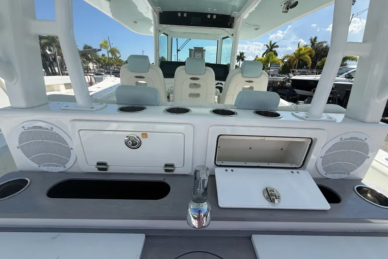 Slide: The Image of 2019 HCB 42 Siesta boat interior with seating, storage, and speakers. - 12