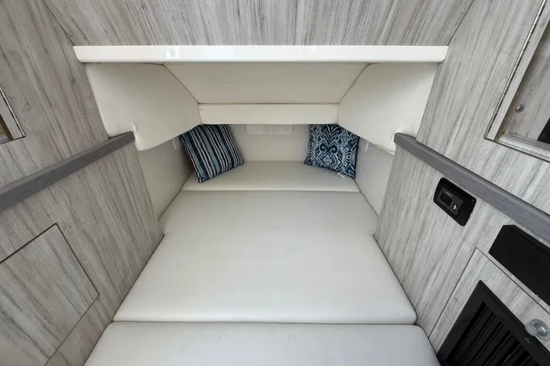 Slide: The Image of 2019 HCB 42 Siesta cabin interior with white bedding and decorative pillows. - 36