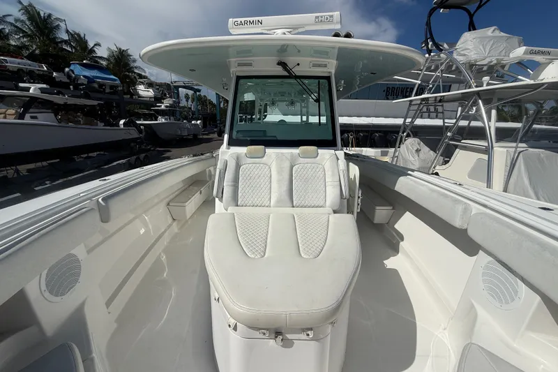 Slide: The Image of 2019 HCB 42 Siesta boat interior with seating and Garmin equipment, docked under clear skies. - 32