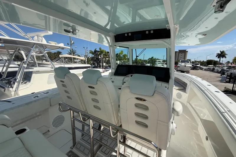 Slide: The Image of Interior view of a 2019 HCB 42 Siesta boat with luxurious seating and modern controls. - 17