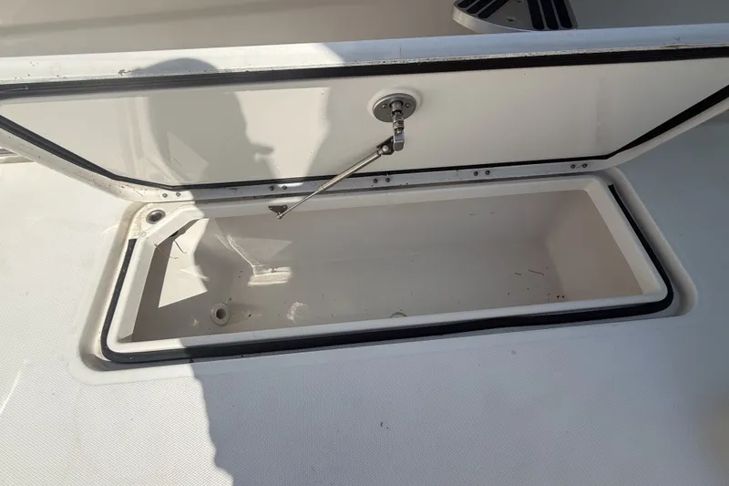 Slide: The Image of Open storage compartment on a 2019 HCB 42 Siesta boat deck. - 16