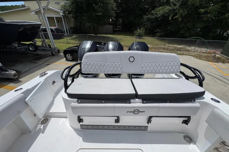 Slide: The Image of 2024 Fountain 34 Tournament Edition boat with cushioned seating and triple outboard motors. - 43