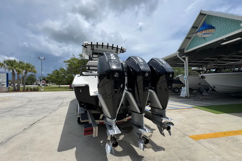 Slide: The Image of 2024 Fountain 34 Tournament Edition boat with triple outboard engines in a marina setting. - 18