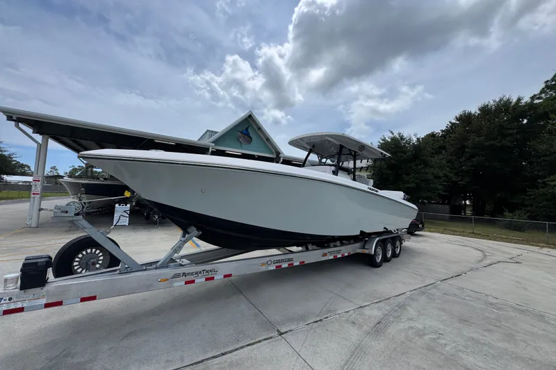 Slide: The Image of 2024 Fountain 34 Tournament Edition boat on trailer, parked outdoors under cloudy sky. - 4